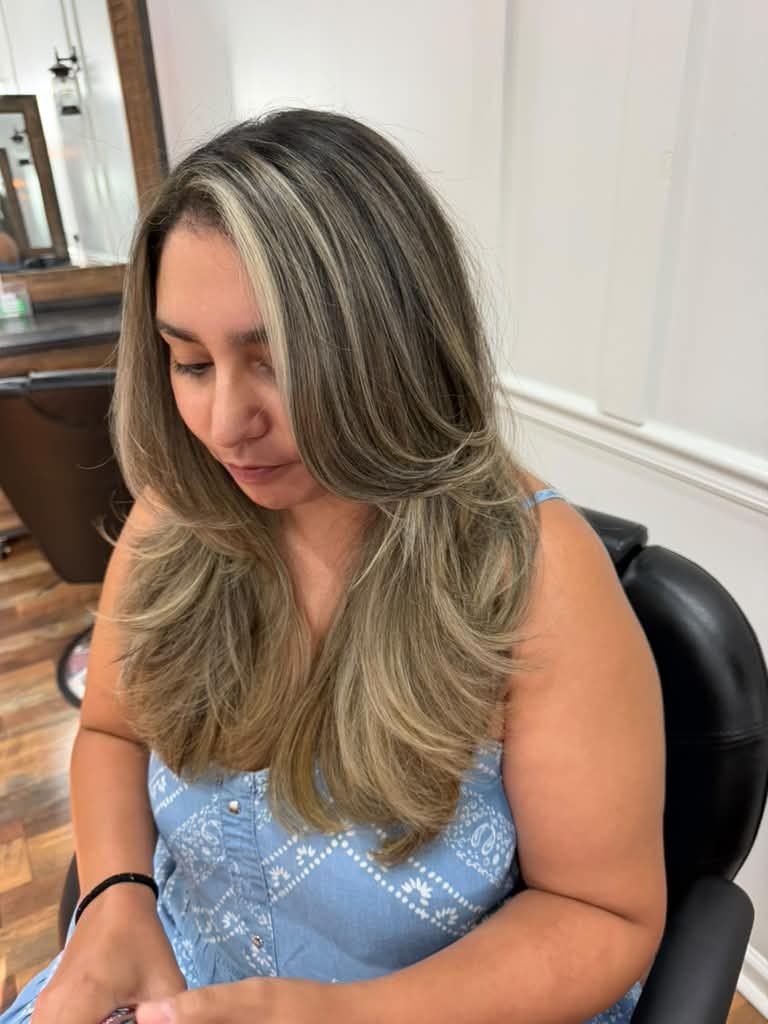 Client with face-framing blonde highlights in the salon